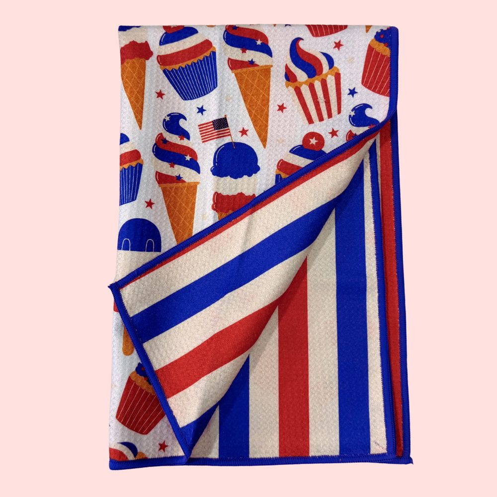 Folded towel with red, white, and blue pattern on a light pink background
