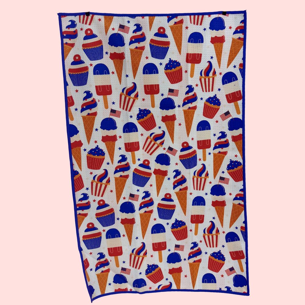 kitchen towel with ice cream cone and cupcake pattern on a pink background