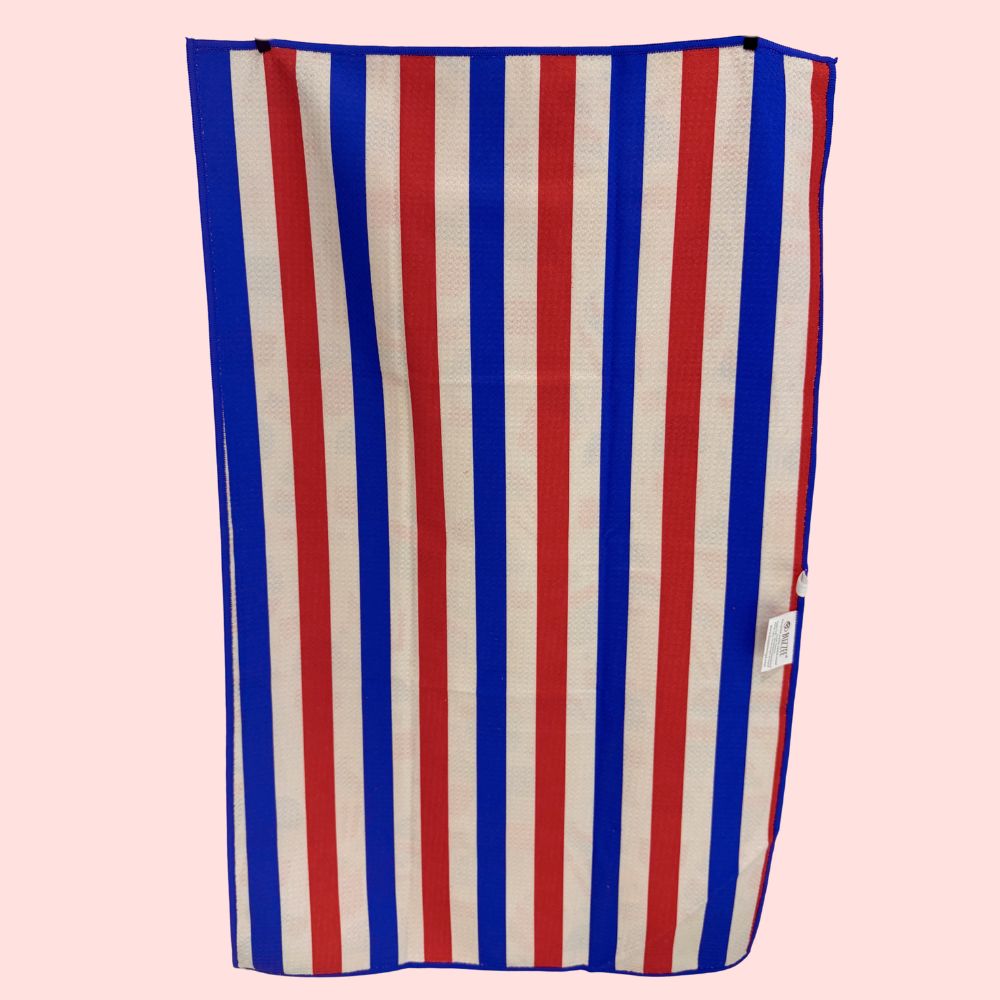 Striped kitchen towel with red, white, and blue vertical stripes on a pink background